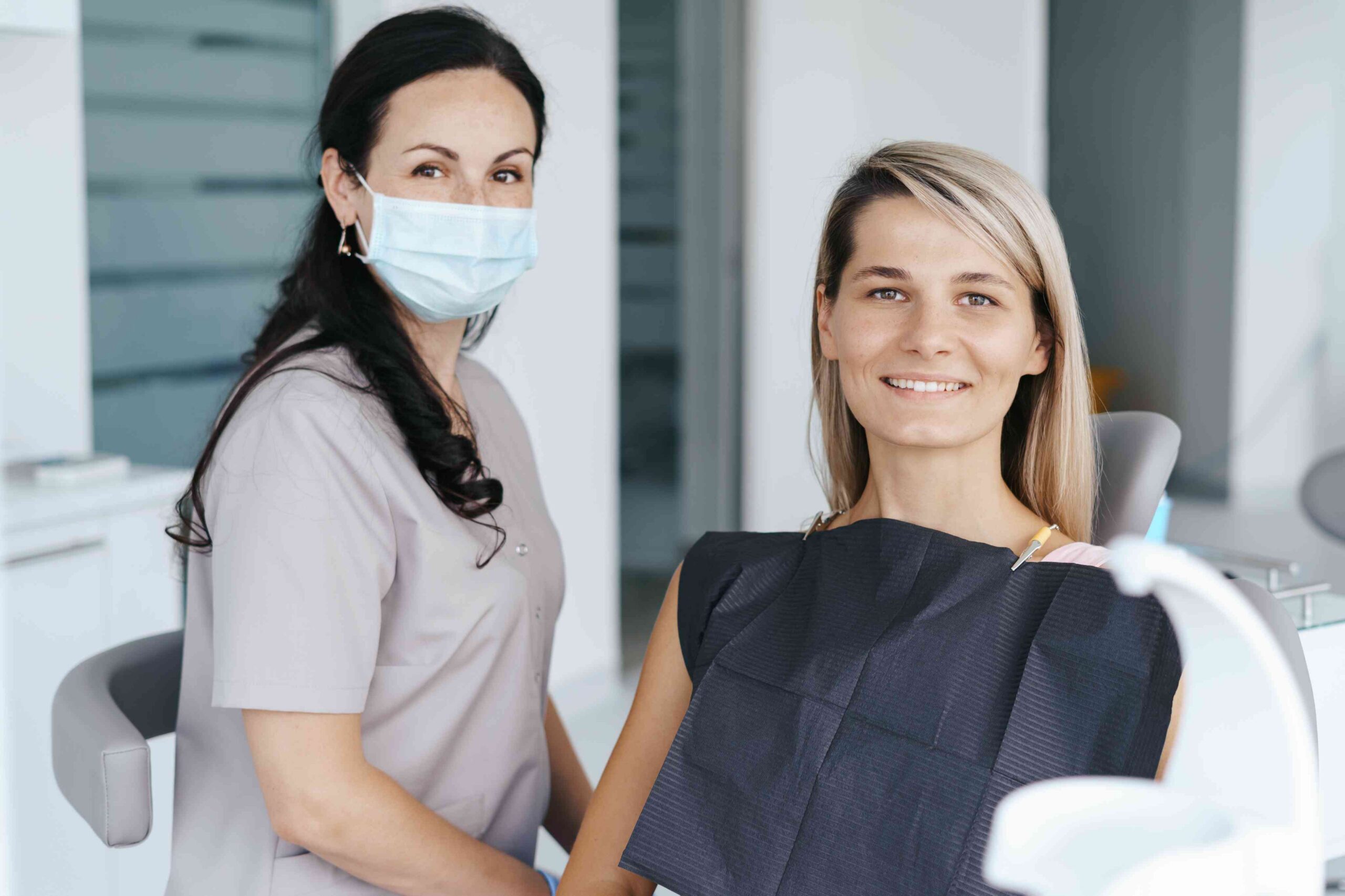 choosing-dentist-everyday-oral-health-needs-pittsfield-township-mi Smiling patient with dental hygienist in a dental office.